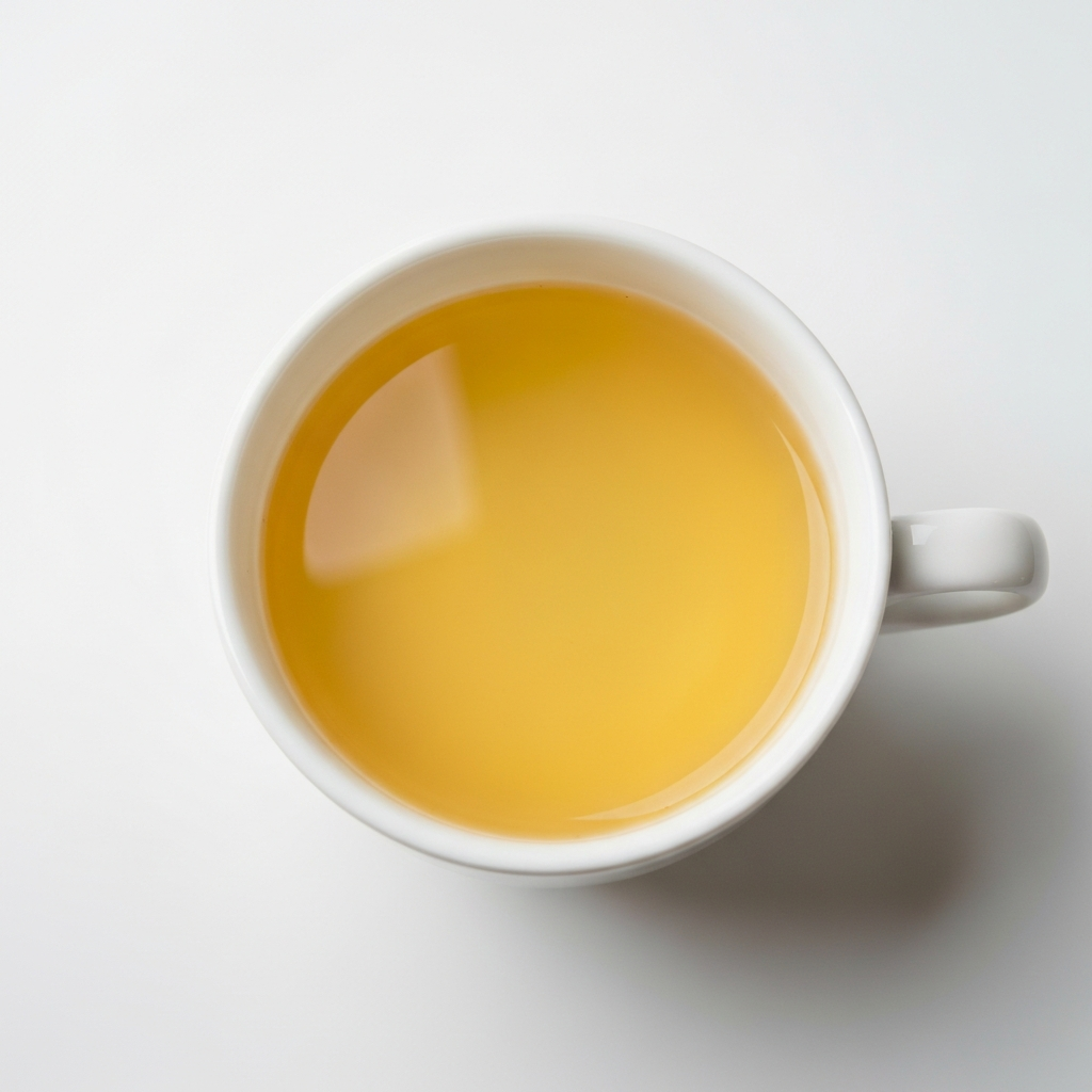 A cup of bright, clear coffee viewed from above